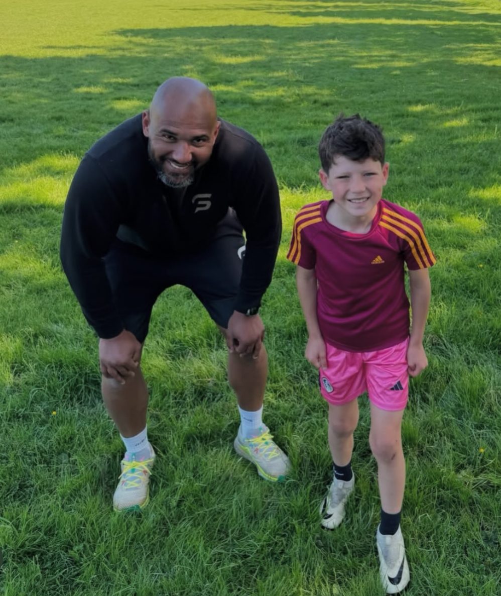 Tim Abeyie coaching sprint starts with a young athlete