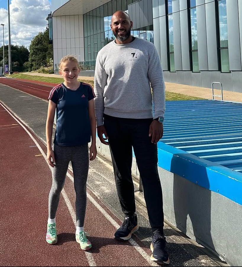 Tim Abeyie coaching on the athletics track
