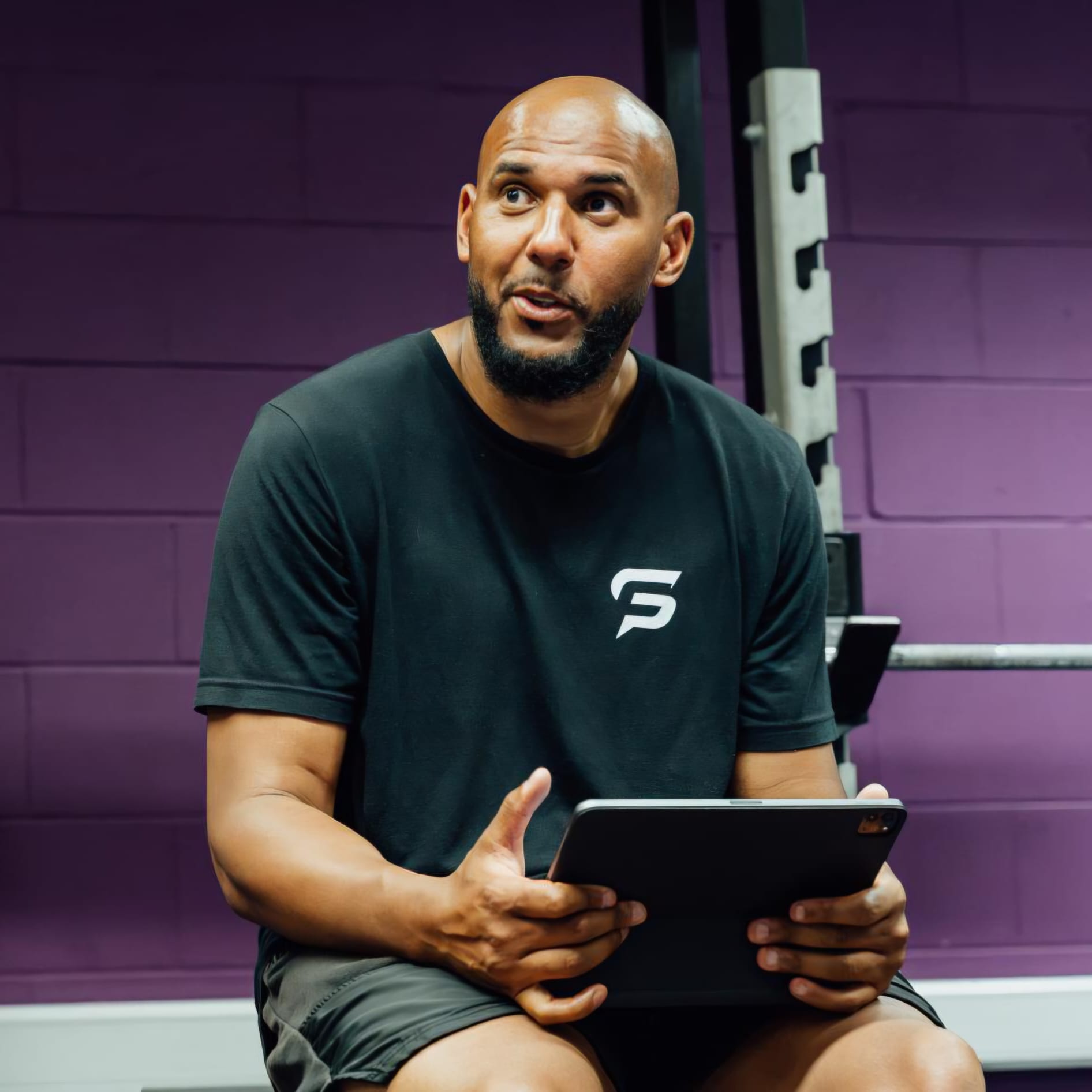 Tim Abeyie, former Team GB sprinter and Speed For Sport founder, coaching from a tablet in the gym