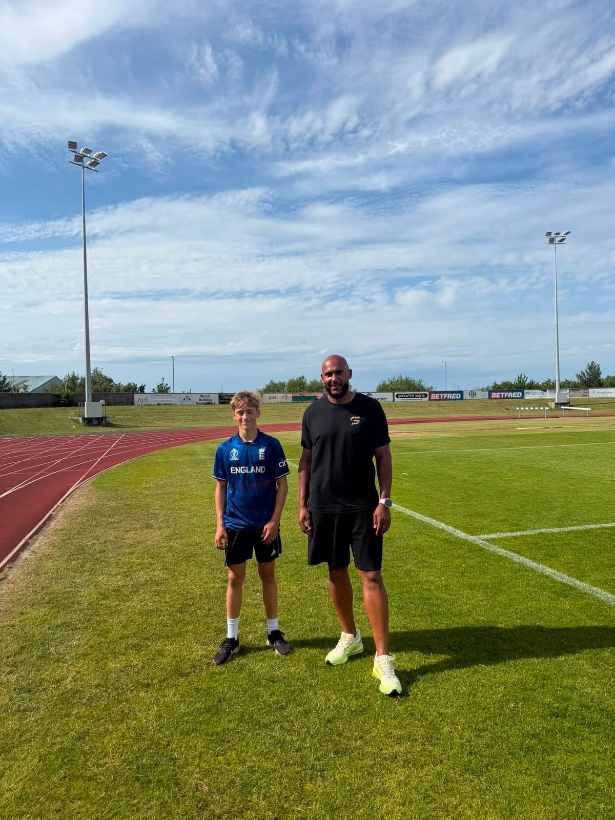 Tim Abeyie with an athlete trackside after a 1-to-1 sprint session